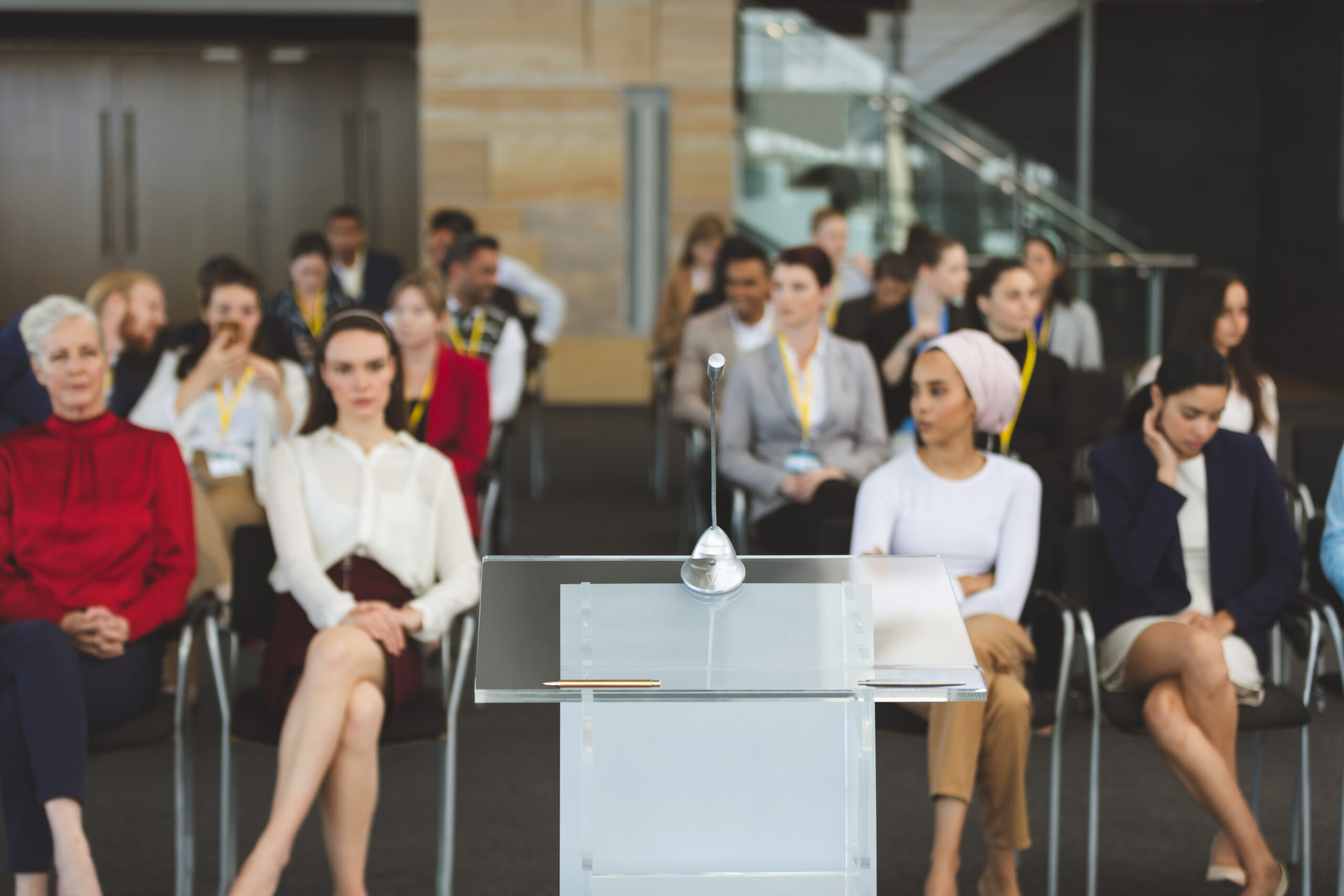 Front view of group of diverse business people attending a business seminar in office building Service Index Service Index
